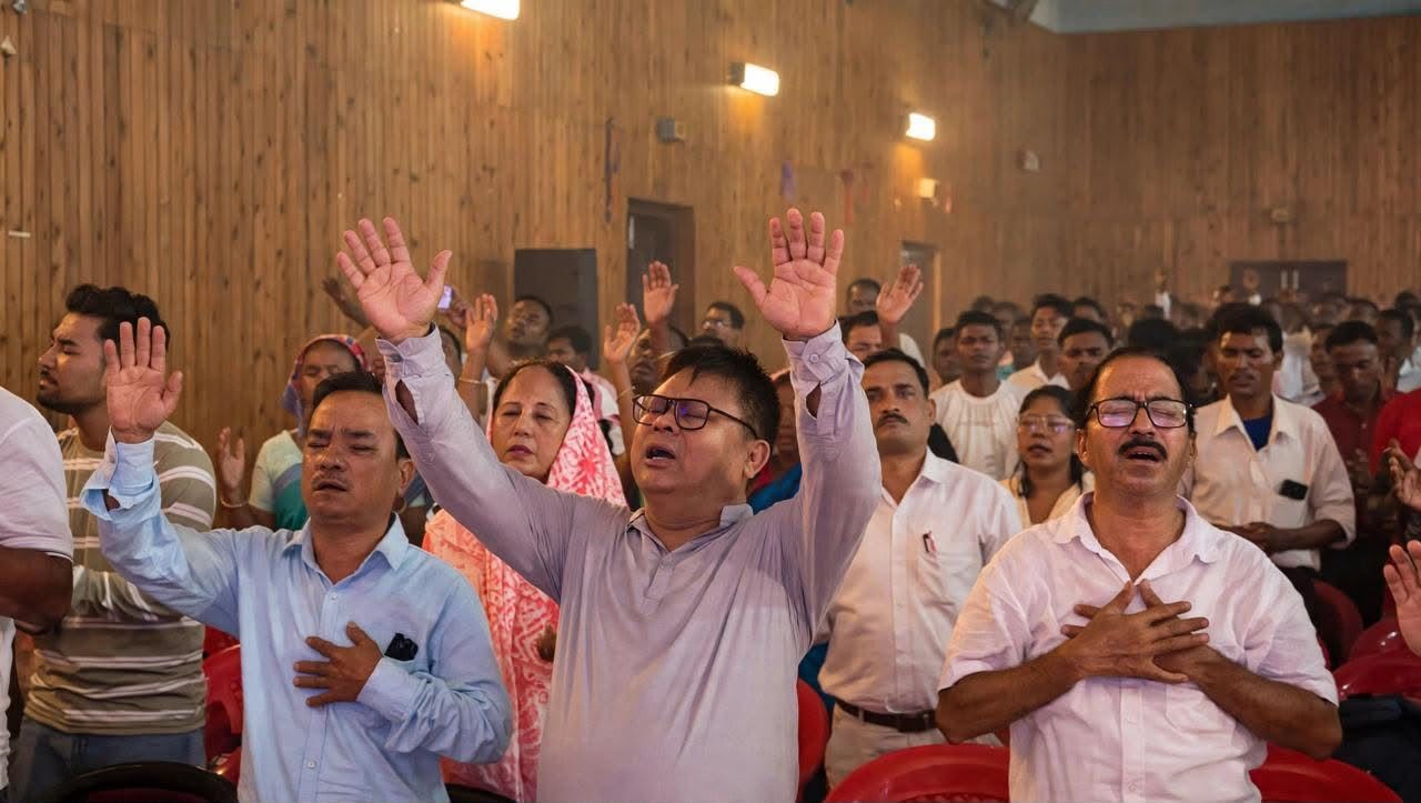 Congregation worshipping in wooden hall
